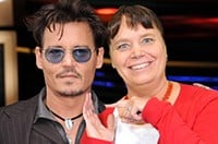 A Las Vegas green screen photo booth featuring a participant posing for a selfie with Johnny Depp