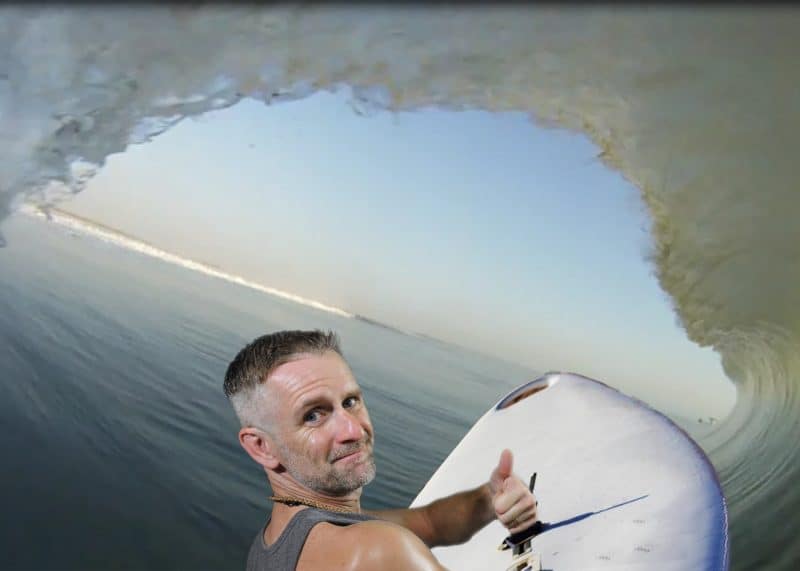 An event participant catches a wave and surfs for this Miami green screen photography event