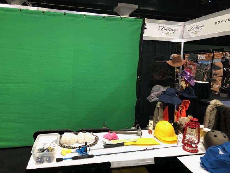 Green screen photo booth props on a table at an experiential photo marketing event.