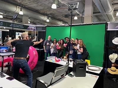 Photographer Mike Gatty poses participants at this Chicago green screen photo booth